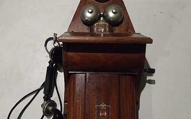 A Danish mahogany and metal wall telephone. Jysk Telefon Aktieselskab. H. 69 D. 25 W. 31 cm.