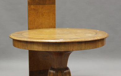 A French Art Deco burr walnut single pedestal extending dining table with a single extra leaf, cross