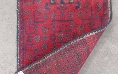 A HAND KNOTTED PURE WOOL AFGHAN