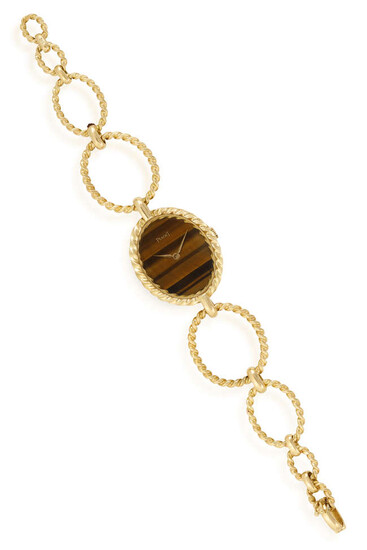 A LADY'S TIGER'S EYE AND 18K GOLD MANUAL...