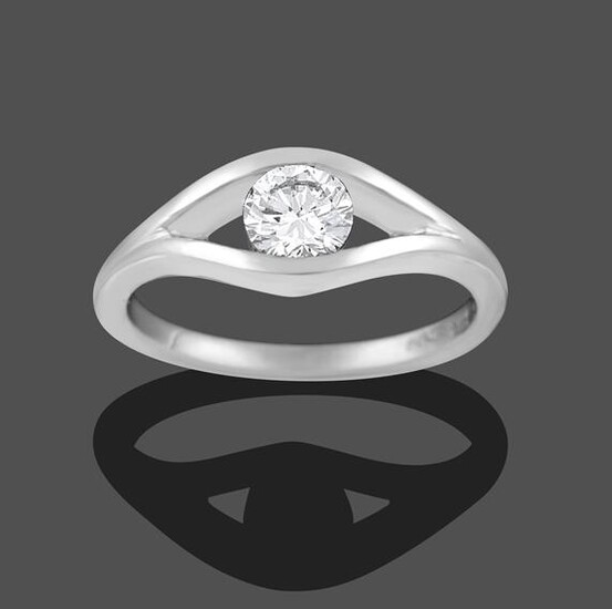 A Platinum Diamond Solitaire Ring, the round brilliant cut diamond tension set within a lozenge...