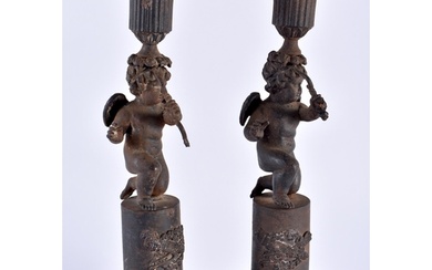 A RARE PAIR OF EARLY 19TH CENTURY FRENCH CAST IRON CANDLESTI...