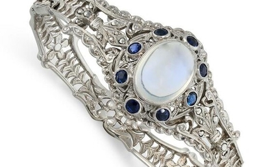A ROCK CRYSTAL AND GEMSET BANGLE in silver, the hinged