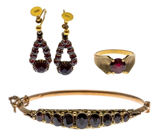 A Suite of Garnet and Gold Jewelry Including a gold bangle with nine graduated garnets mounted...