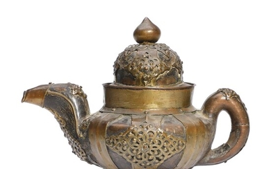 A Tibetan wood and leather teapot mounted with brass decoration. 19th century....