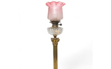 A VICTORIAN OIL LAMP with a large brass Corinthian column re...
