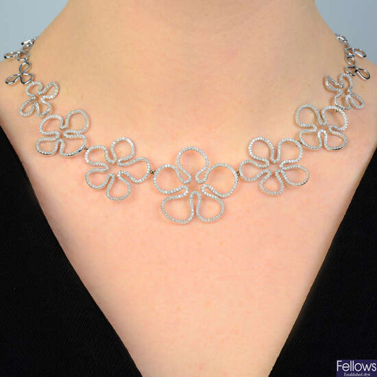 A brilliant-cut diamond graduated floral-link necklace, with similarly-designed polished back-chain.