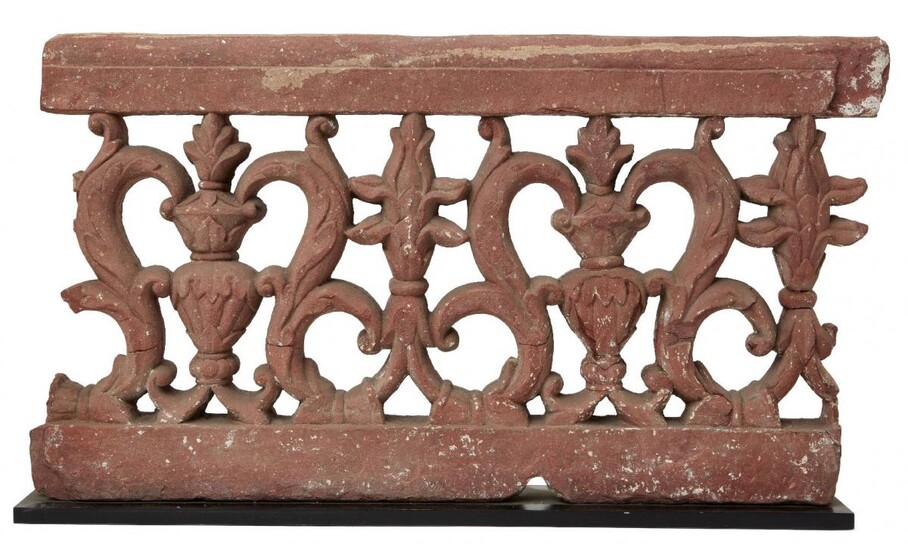 A carved and pierced double-sided sandstone balustrade fragment, Agra, India, period of Shah Jahan mid-17th century, with flower buds alternating with flowering vases on a ground of openwork scrolling vine, 37cm. high x 67cm wide This fragment...