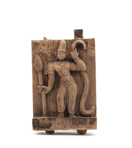 A carved wood panel depicting Rama with his bow