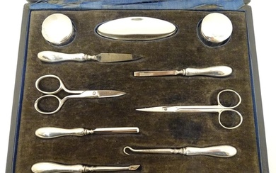 A cased manicure set / necessaire containing silver mounted ...