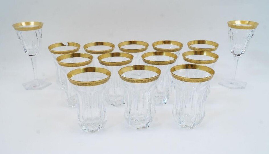 A collection of Moser cut crystal glasses, 20th century, etched factory mark to underside, each with gilded vine border to the rim, to include two hexagonal panelled goblets on tapering stems and hexagonal feet, 18.7cm high, 8.5cm diameter, and...