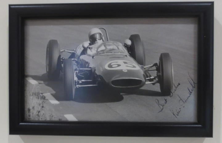 A collection of small monochrome motor racing images of cars and drivers