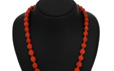 SOLD. A graduated coral necklace set with numerous polished coral beads, clasp of gold plated...