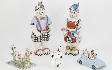 A group of Villeroy & Boch novelty ceramic cat figures, to include two standing figures, one figure in a hammock and a figural group in a car, and a black and white fat cat, each with printed factory stamp, tallest 40cm high (5)