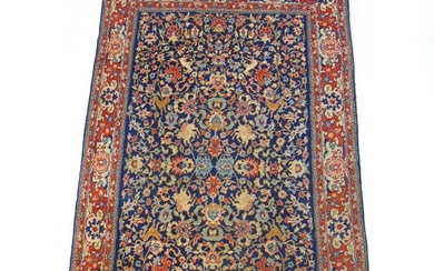 A handwoven Persian rug the multi line border surrounding the...