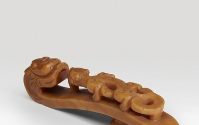 A large Chinese carved caramel-yellow agate "dragon"