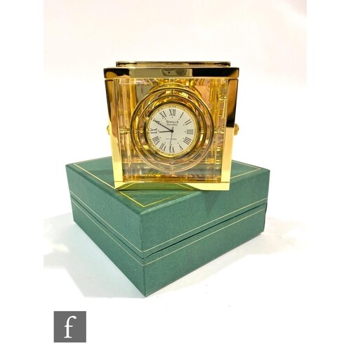 A late 20th Century square brass bedside clock with internal...