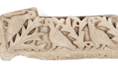 A limestone relief fragment depicting three doves in foliage, not ancient, 44.5 x 15.2cm.