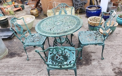 A metal garden table and four chairs painted green.