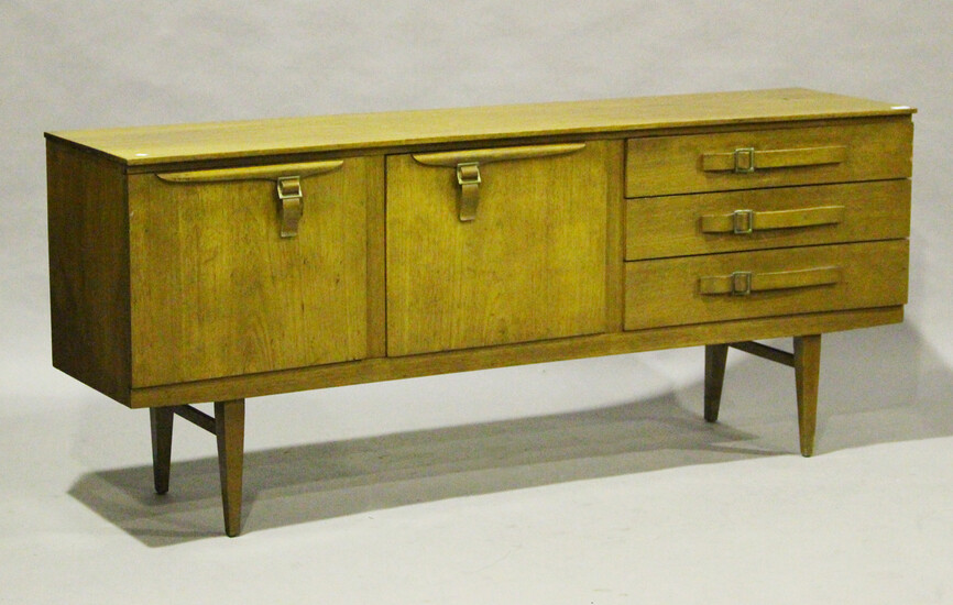 A mid-20th century teak sideboard by Beautility, the inverted front fitted with stylized belt buckle