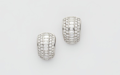 A pair of 18k white gold and diamond clip earrings.