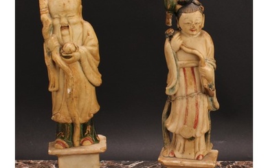 A pair of Chinese soapstone figures, carved as Shou Lao and ...