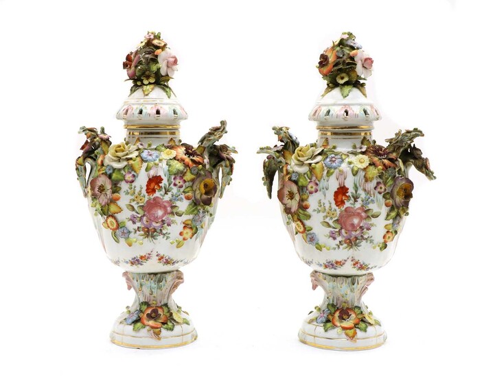 A pair of Continental lidded porcelain urns