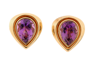 A pair of amethyst earclips Each collet-set pear-shaped...