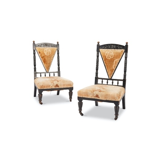 A pair of late Victorian Aesthetic period ebonised salon cha...
