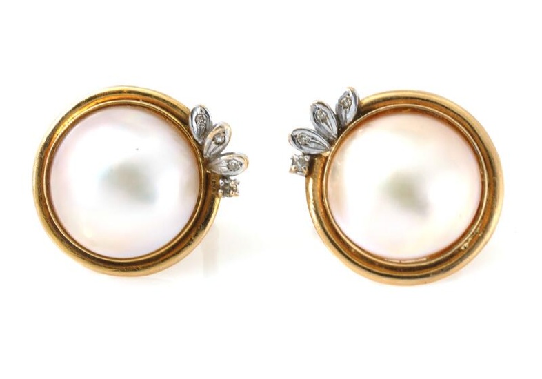 A pair of mabé pearl and diamond ear clips each set with...
