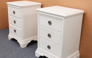 A pair of off-white painted three-drawer bedside cabinets in...