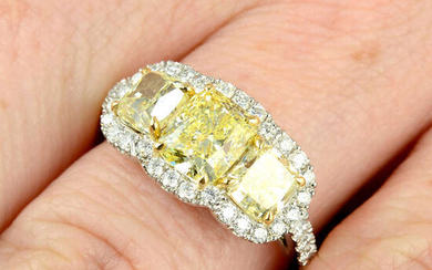 A platinum 'yellow' diamond and diamond three-stone cluster ring.