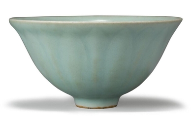 A rare Chinese Longquan kinuta seiji celadon 'lotus petal' bowl, Southern Song dynasty, on short foot with deep, rounded sides that rise to an everted rim, the exterior moulded with a band of vertical lotus petals, covered in an allover pale...