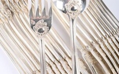A set of eleven pieces of cutlery and a silver table spoon, the handle decorated with a net ending in a shell and surmounted by a flowered branch, encrypted.