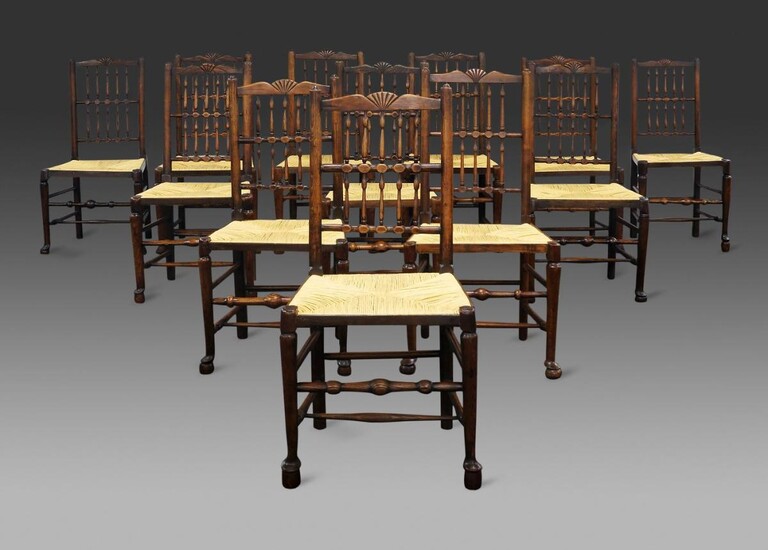 A set of twelve ash and elm fan backed chairs, early 19th century, with spindle back rests, raised on tapering legs and hoof feet, joined by stretchers