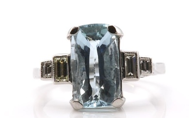 A single stone aquamarine ring with diamond set shoulders