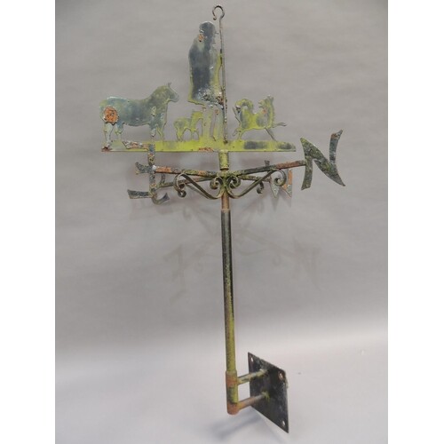 A wrought iron weather vane with shepherd sheep, and sheep d...
