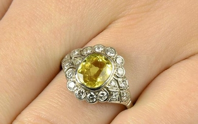 A yellow sapphire and diamond cluster ring.Sapphire