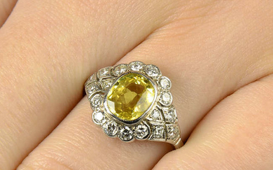 A yellow sapphire and diamond cluster ring.