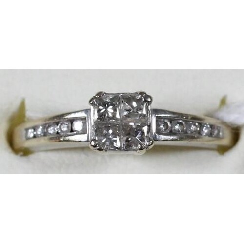 An 18ct white gold diamond ring, claw set with four Princess...