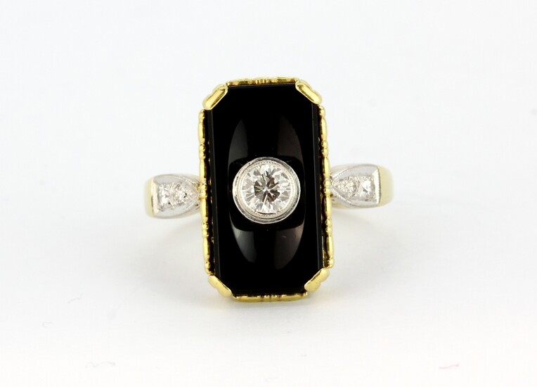 An 18ct yellow gold (stamped 750) ring set with onyx and a brilliant cut diamond, with diamond set shoulders, approx. 0.30ct centre stone, (