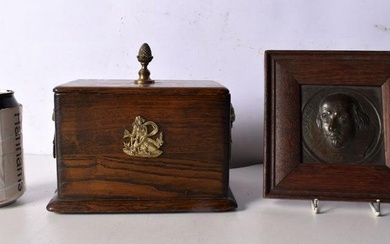 An Antique wooden box with brass Lion head handles together with a framed bronze head of Shakespeare