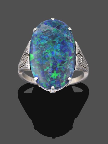 An Art Deco Black Opal and Diamond Ring, the oval black opal in a white claw setting, to beaded...