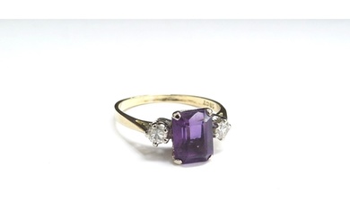 An amethyst and diamond ring the central emerald cut amethys...