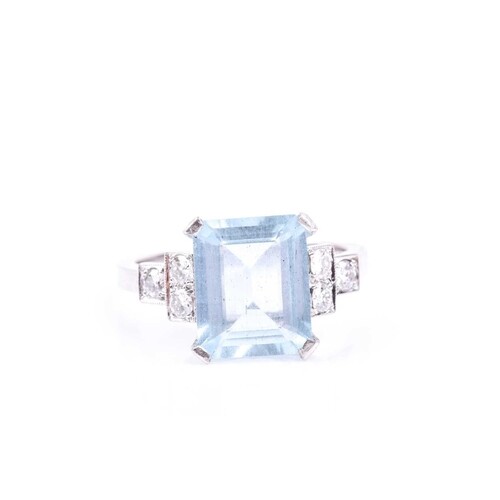 An aquamarine and diamond ring, set with an emerald-cut aqua...