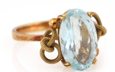 An aquamarine ring set with an oval-cut aquamarine, mounted in 18k gold...