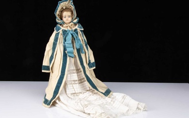 An early 19th century English wax over papier-mâché doll