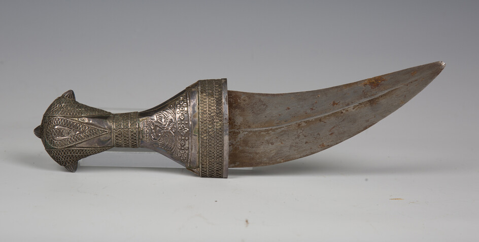 An early 20th century Arabian silver mounted jambia with curved double-edged blade, blade length 12.