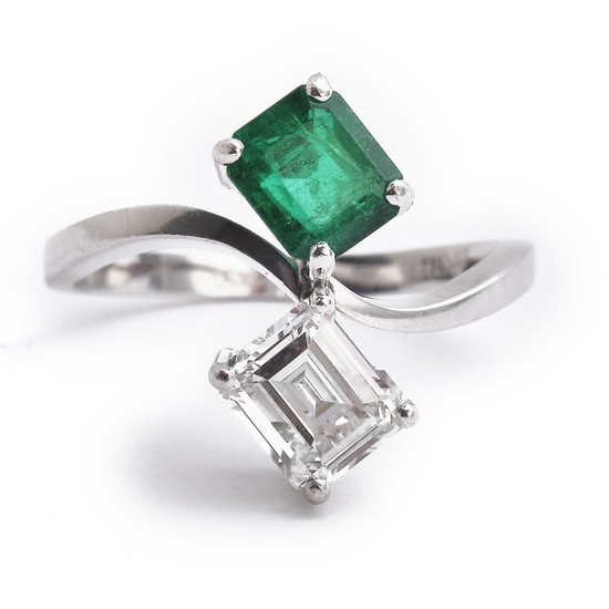 An emerald and diamond ring set with an emerald-cut emerald and a rectangular baguette-cut diamond weighing app. 1.00 ct., mounted in 18k white gold. H/VVS.