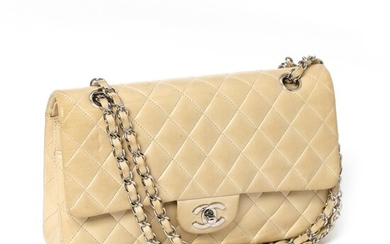 Chanel A “Classic Double Flap” bag of beige quilted leather with silver...